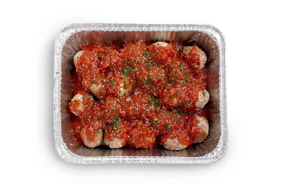 Tray of Italian meatballs over spaghetti