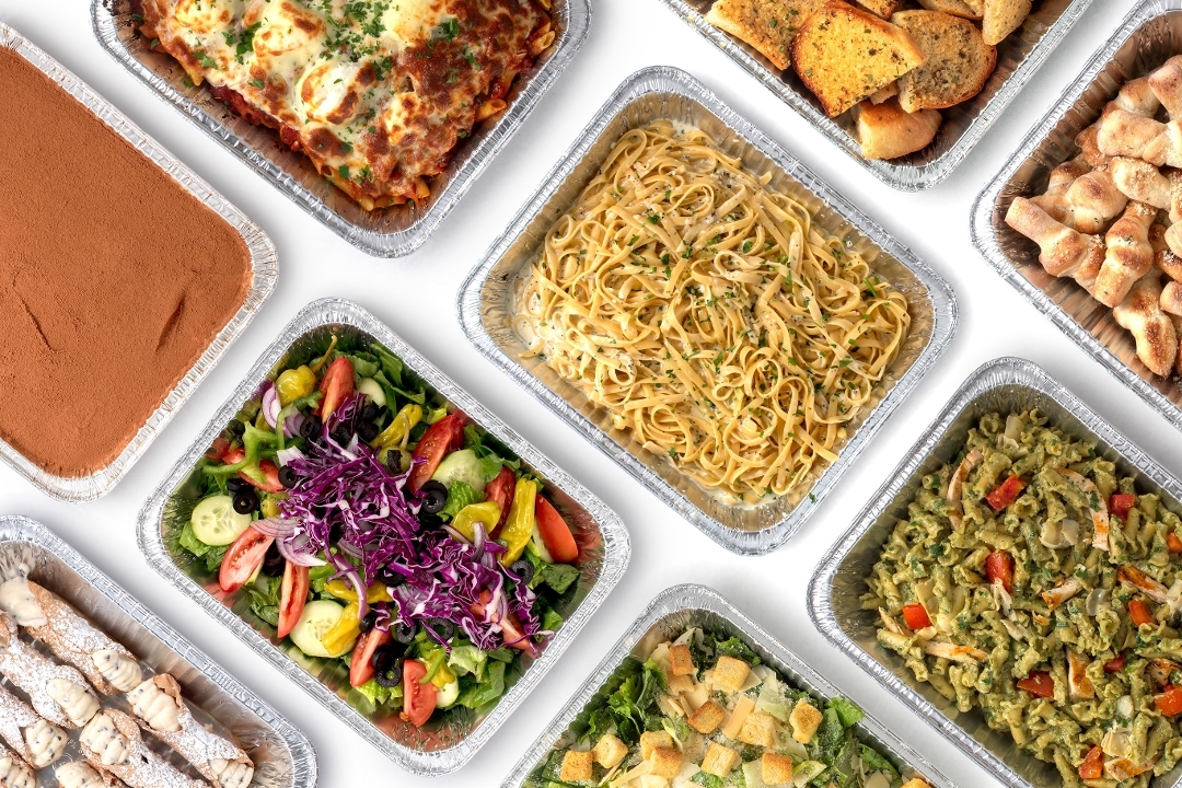 Pasta trays with salad, garlic knots, and tiramisu